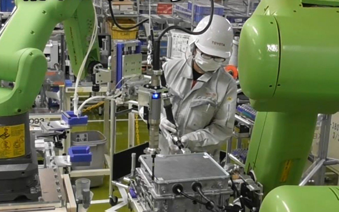 Photo: An image of humans and robots working side by side