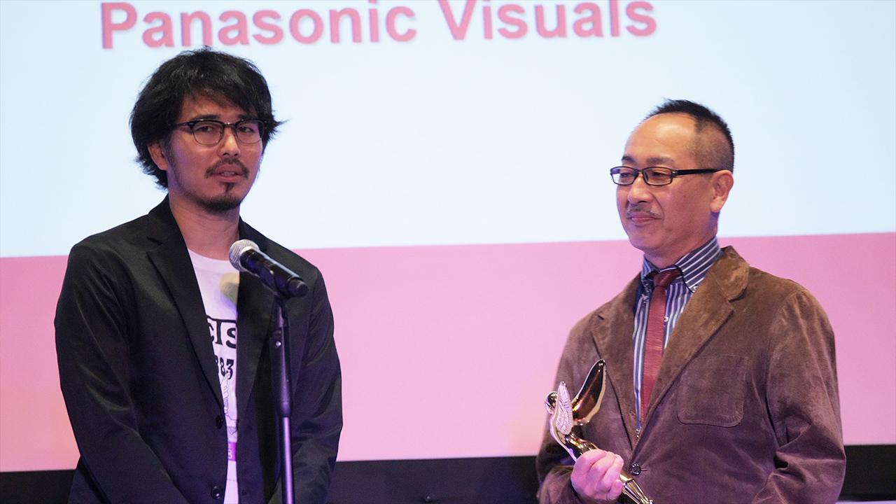 photo: Panasonic Corporation's Masaru Kojima and Panasonic Visual's Naoki Anraku, Director, comment on the award.