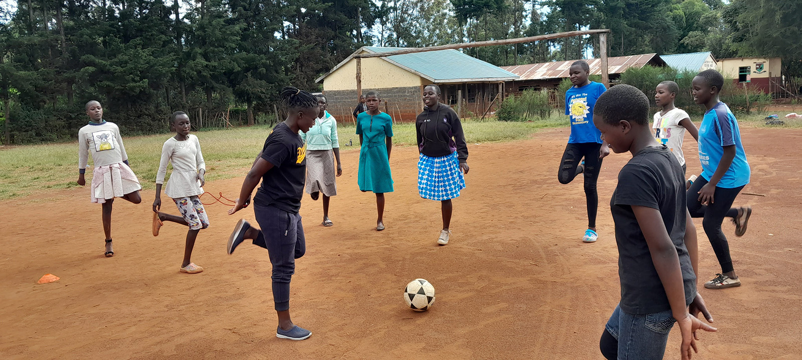 Photo: Pauline encourages local children to warm up before a game of soccer