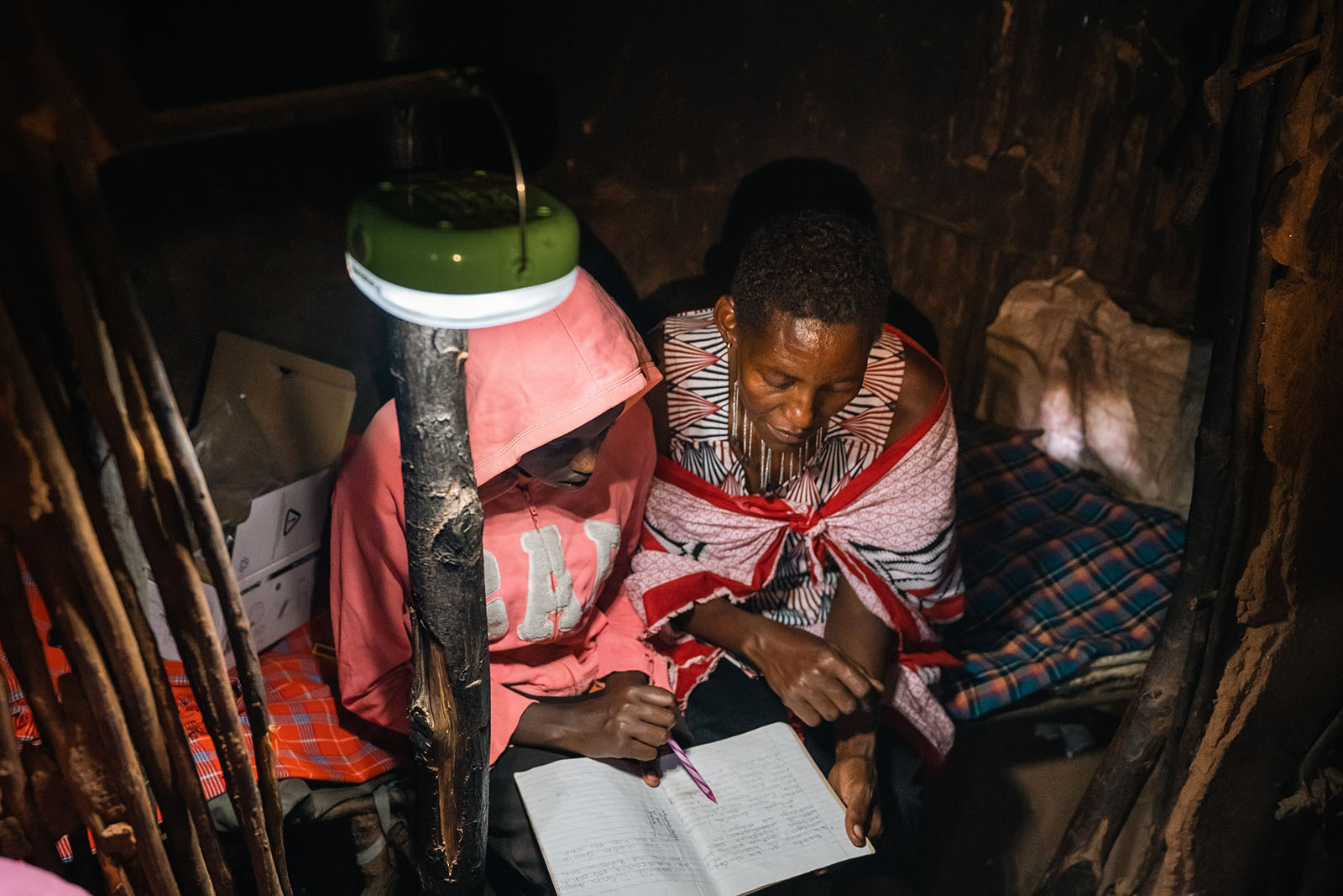 Photo: Women learn literacy by the light of solar lanterns