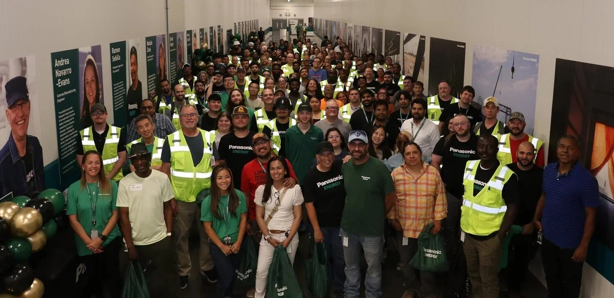 Kansas factory entrance displaying employee photos and their stories.
