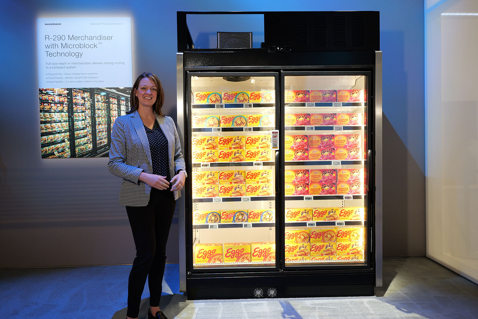 Sarah Greenwood beside Hussmann’s RLN2A refrigerated and frozen food display cases