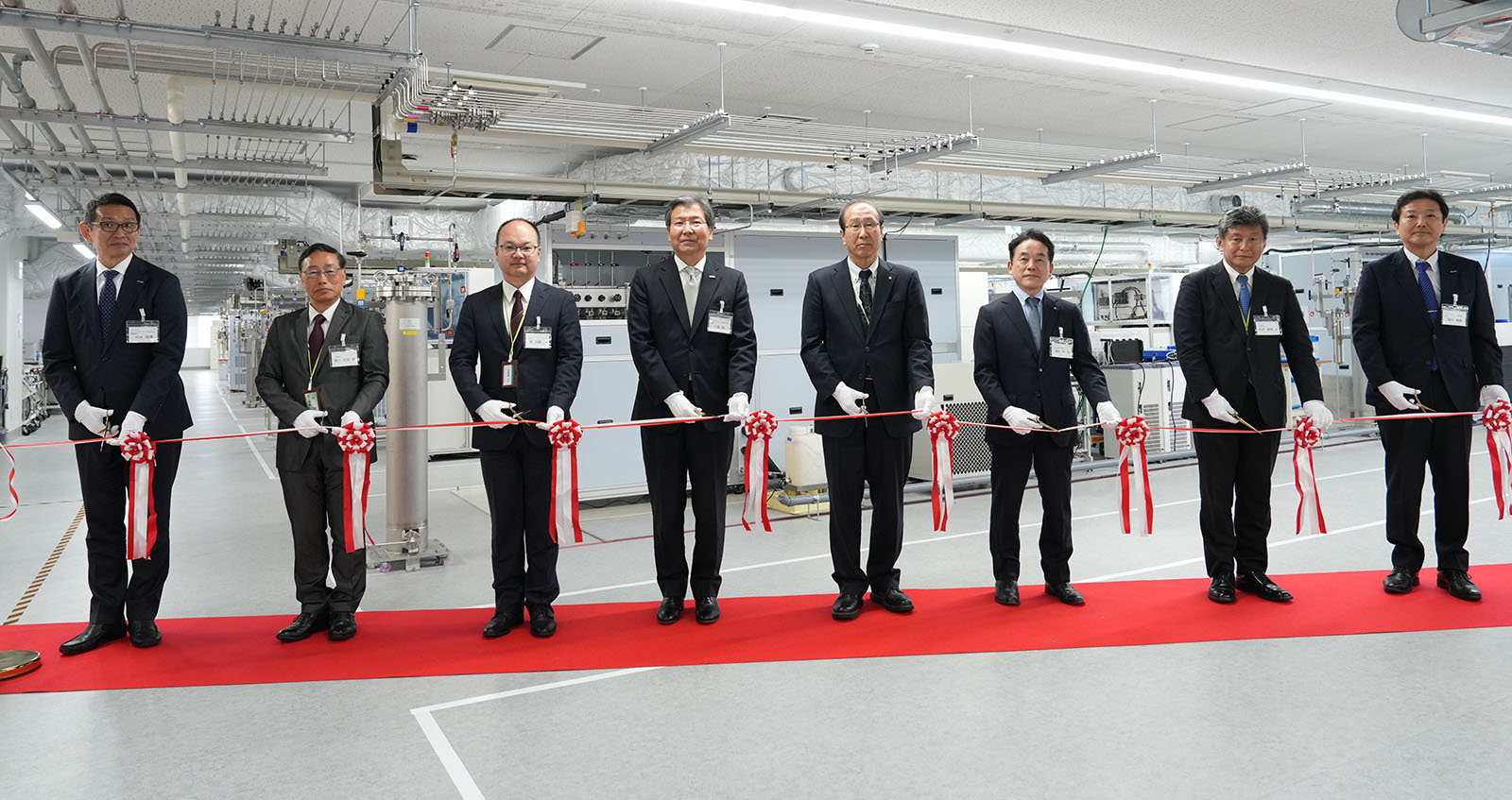 Participants prepare to cut the ribbon at the opening ceremony.